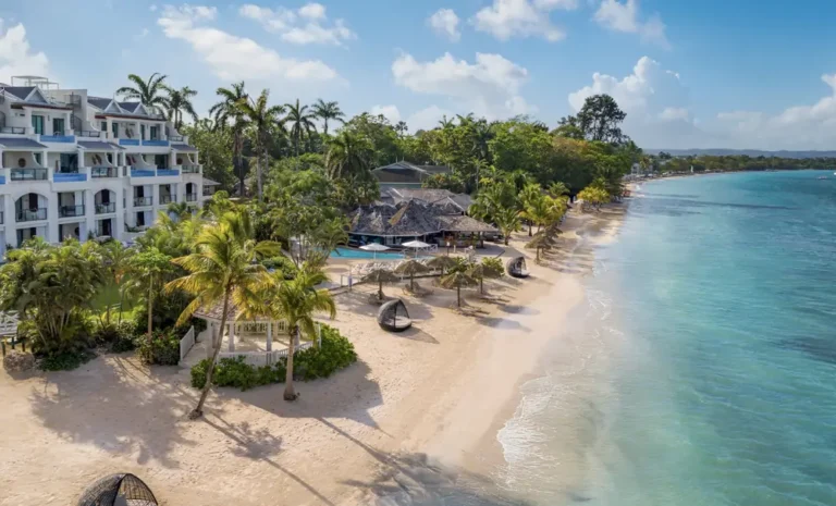Aerial view of the beachfront, palms and turquoise water at Sandals Negril Beach Resort & Spa