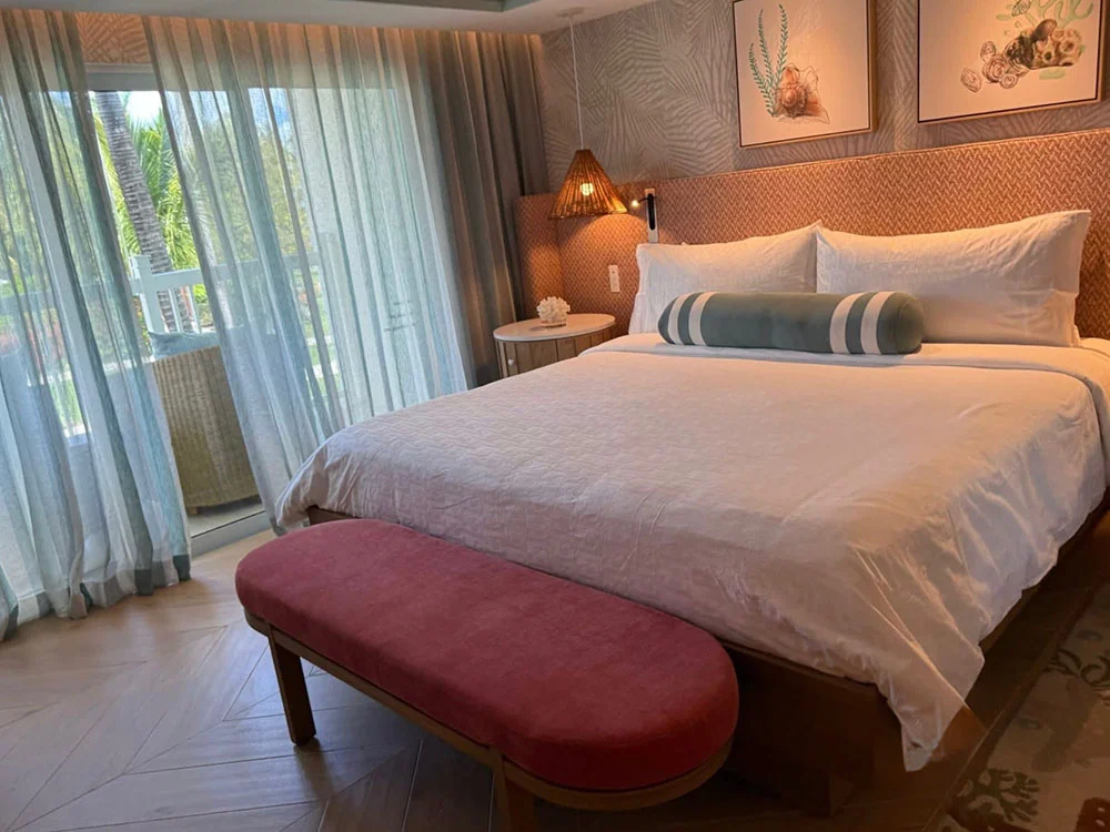 King bed guest room interior with coastal decor at Beaches Turks and Caicos Caribbean Village