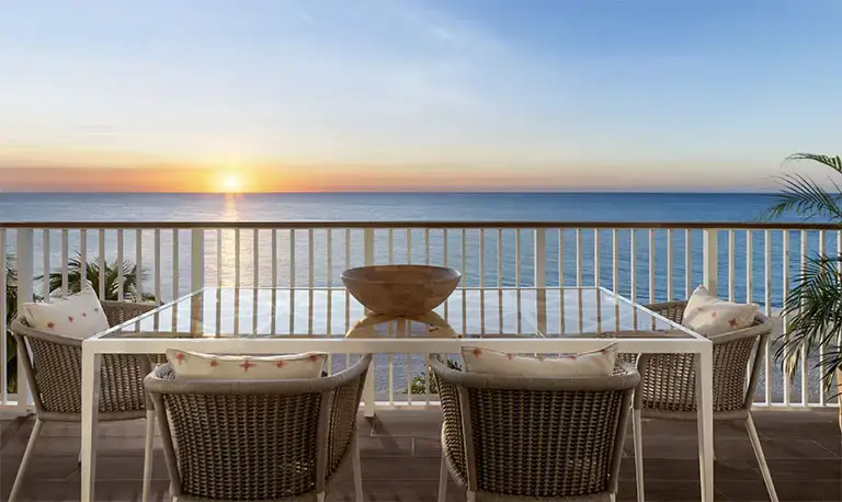 Oceanview balcony seating at sunset at Beaches Negril