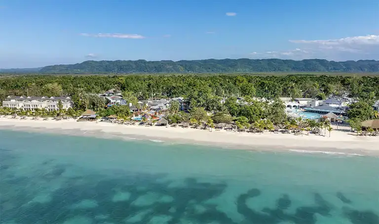 Aerial view of the beachfront resort and mountains at Beaches Negril