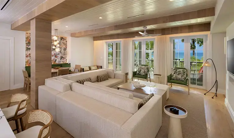 Suite living room with ocean-view balcony at Beaches Negril