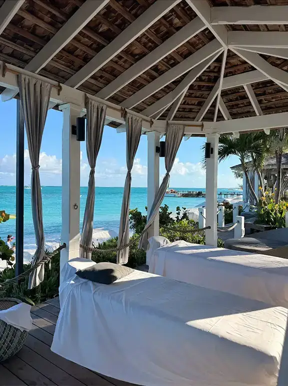 Oceanfront cabana lounge with curtained daybeds at Beaches Turks & Caicos