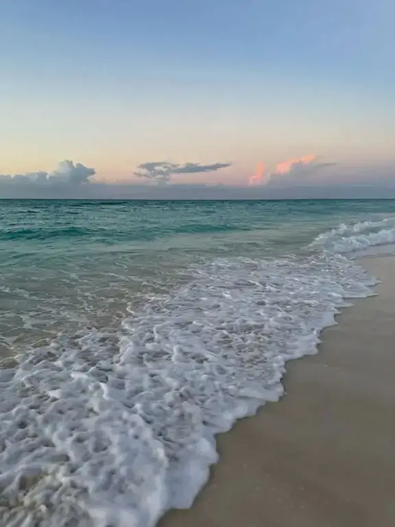 Turquoise waves washing onto the shore at sunset, Beaches Turks & Caicos