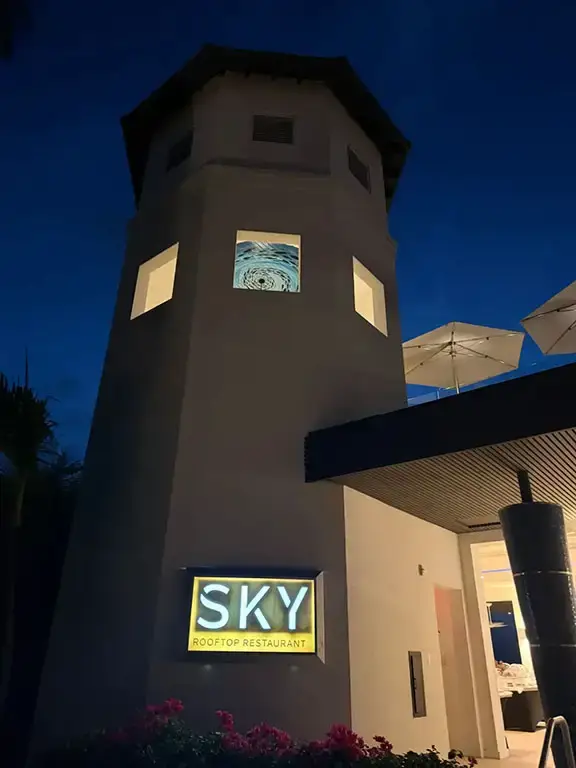 Sky restaurant tower lit up at night at Beaches Turks & Caicos
