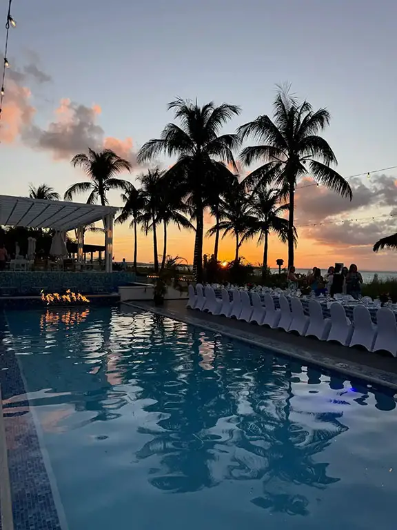 Pool deck with palm trees at sunset, Beaches Turks & Caicos
