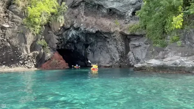 Kayakers exploring a sea cave, part of a Caribbean adventure excursion