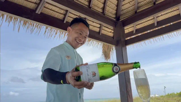 Butler service pouring champagne at a Sandals or Beaches resort