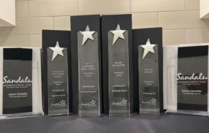 Sandals Chairman's Royal Club Platinum and Elite award trophies for Jason and Karen Cavadas of Twinsburg Travel