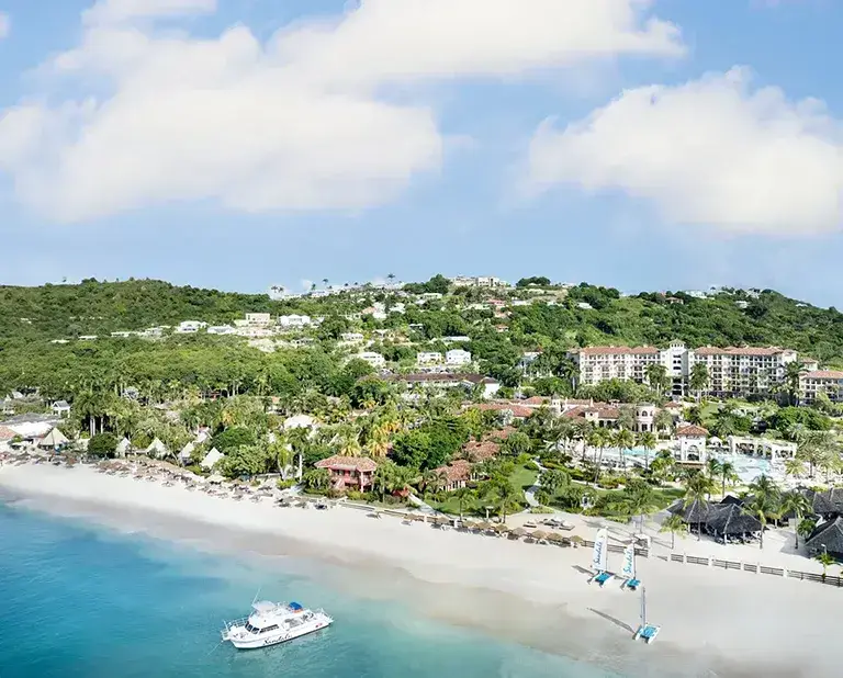 Aerial view of Sandals Grande Antigua resort along the hillside and beach