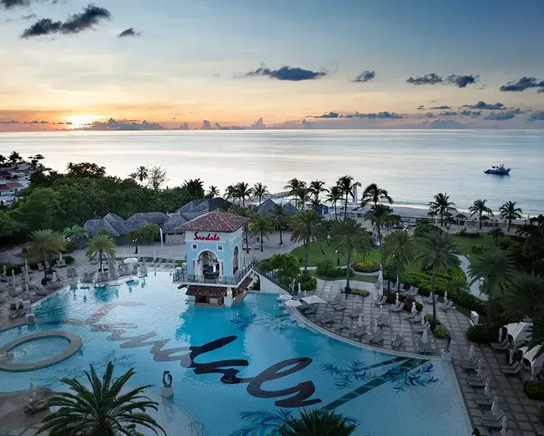Aerial sunset view of the pool and ocean at Sandals Grande Antigua