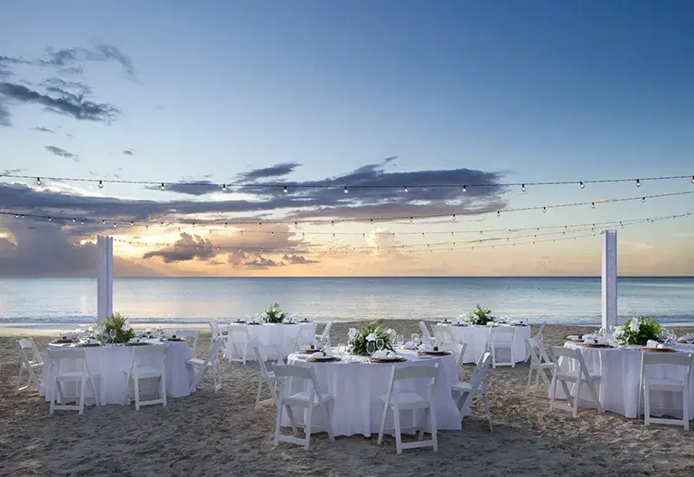 Beach wedding reception at sunset at Sandals Grande Antigua