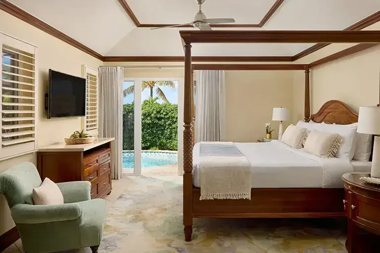 Luxury villa bedroom with private pool view at Sandals Grande Antigua