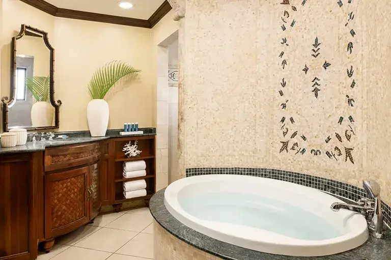Suite bathroom with mosaic tile accent wall at Sandals Grande Antigua