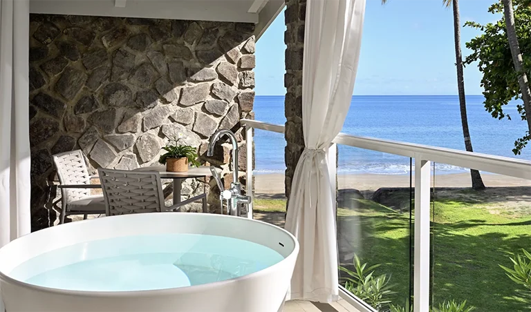 Balcony soaking tub with ocean view at Sandals Halcyon Beach