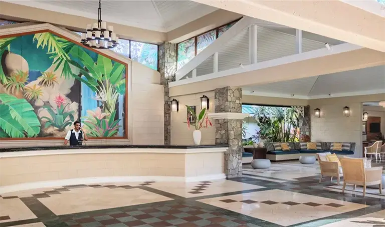 Lobby with checkered floor and tropical mural at Sandals Halcyon Beach