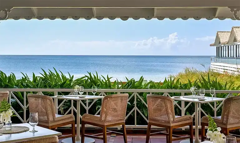 Oceanfront dining terrace at Sandals Halcyon Beach