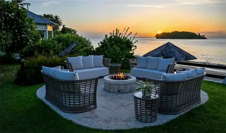 Oceanview fire pit lounge seating at sunset at Sandals Halcyon Beach