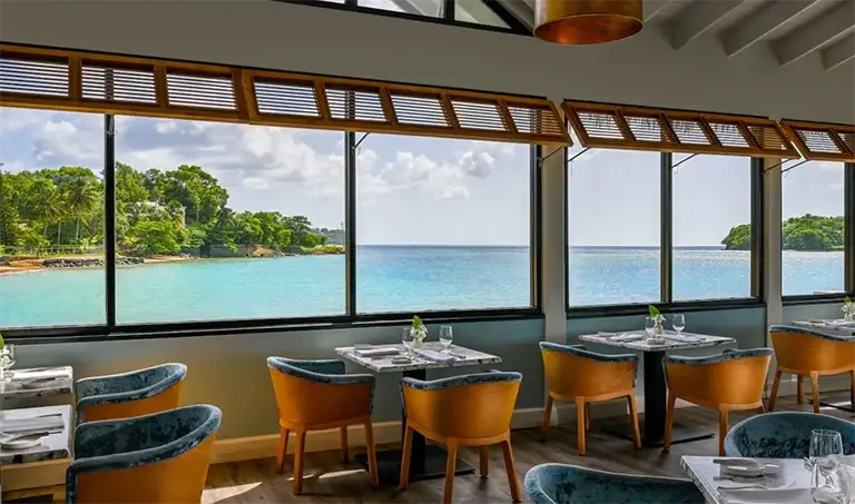 Oceanview restaurant with large windows at Sandals Halcyon Beach