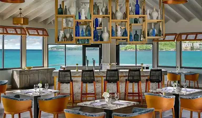 Restaurant and bar with ocean view at Sandals Halcyon Beach