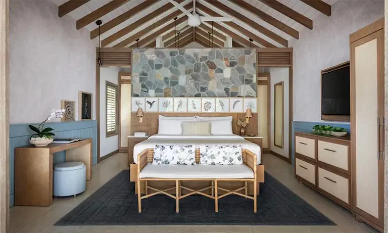 Villa bedroom with vaulted ceiling at Sandals Halcyon Beach