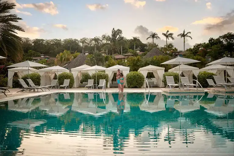 Couple entering the main pool at Sandals La Source Grenada