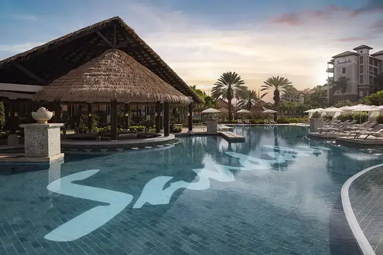 Sunset over the South Seas pool at Sandals La Source Grenada