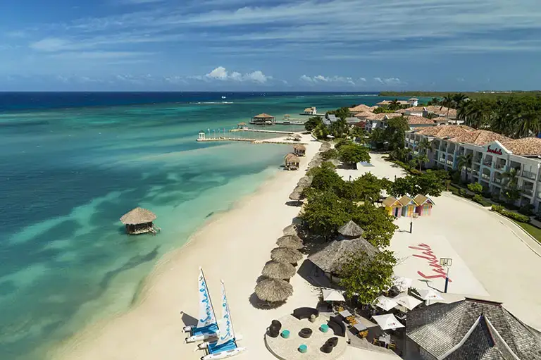 Aerial drone view of the beach and basketball court at Sandals Montego Bay