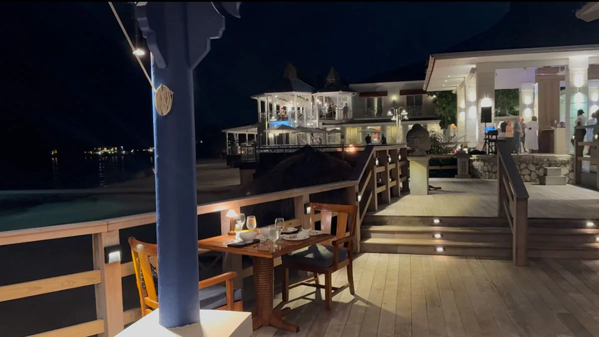 Oceanfront dining table at Oleanders restaurant with sunset beach view at Sandals Montego Bay