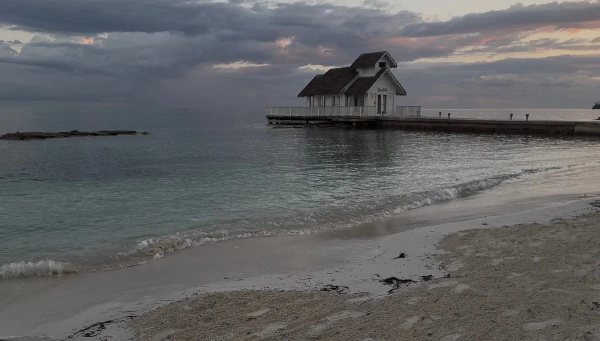 White wedding chapel at the end of a pier at sunset at Sandals Montego Bay