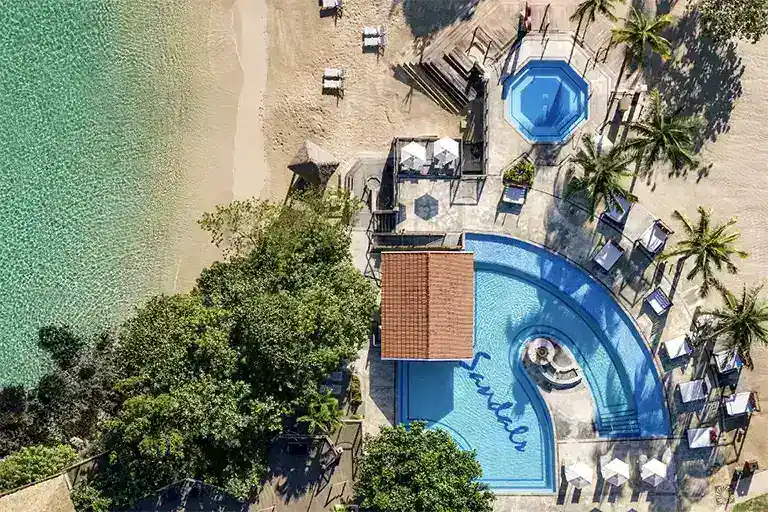 Aerial view of beachfront pool with Sandals logo at Sandals Ochi Rios