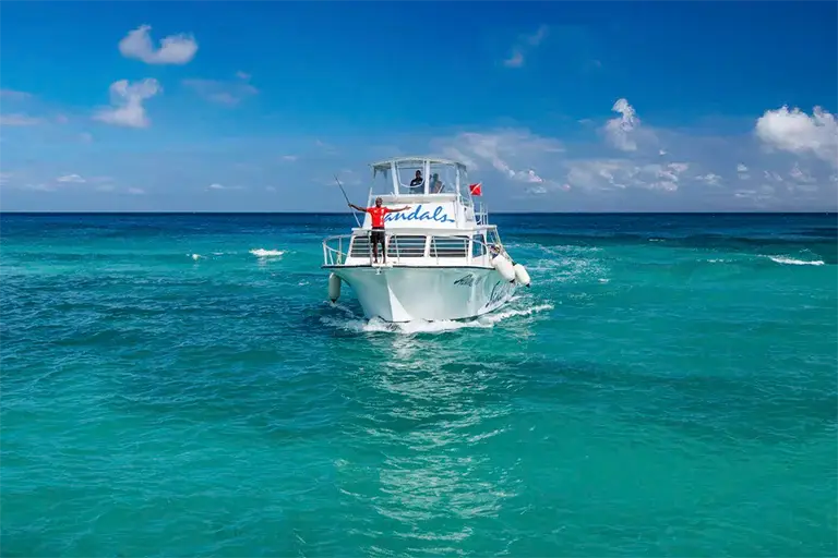 Catamaran boat cruising in turquoise waters at Sandals Ochi Rios