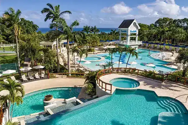 Sandals Ochi Rios resort pool area with multiple pools and palm garden