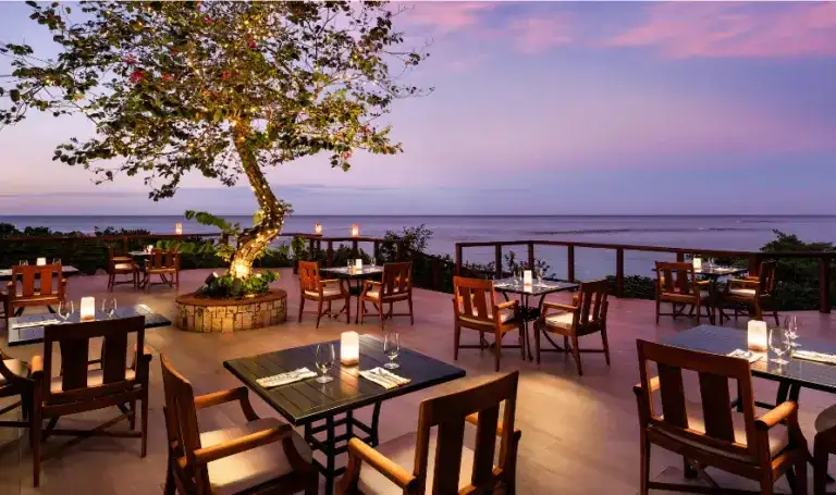 Oceanview dining terrace at dusk at Sandals Ochi Beach Resort