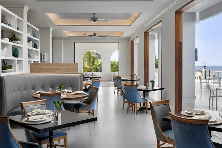 Elegant oceanview restaurant interior at Sandals Ochi Rios with dining tables