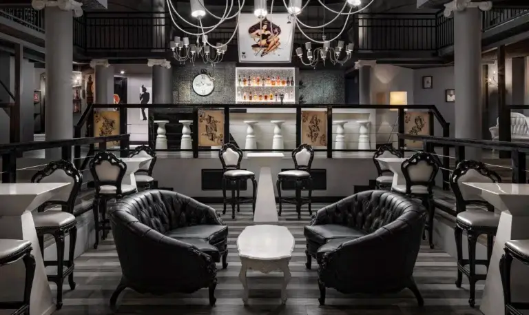 Elegant dark lounge bar interior with chandeliers at Sandals Ochi Rios