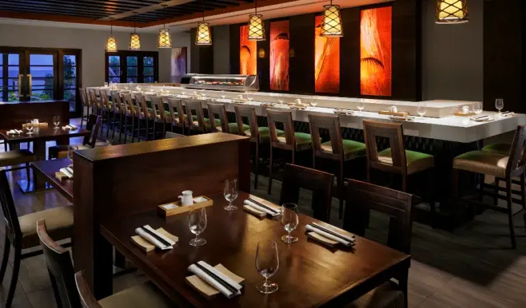 Sushi bar restaurant interior with counter seating at Sandals Ochi Rios