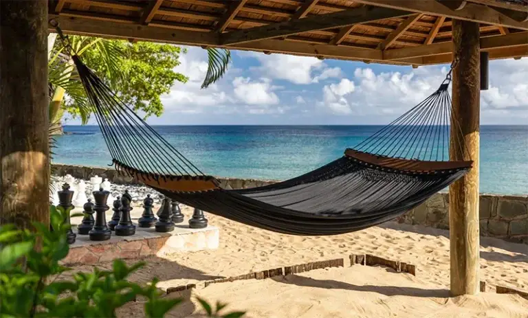 Beachfront hammock and chess set at Sandals Regency La Toc