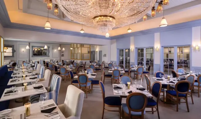 Elegant restaurant dining room with grand chandelier at Sandals Royal Bahamian