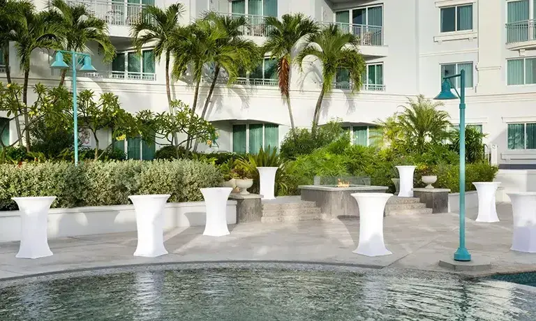 Courtyard misting cabana surrounded by palm trees at Sandals Royal Bahamian