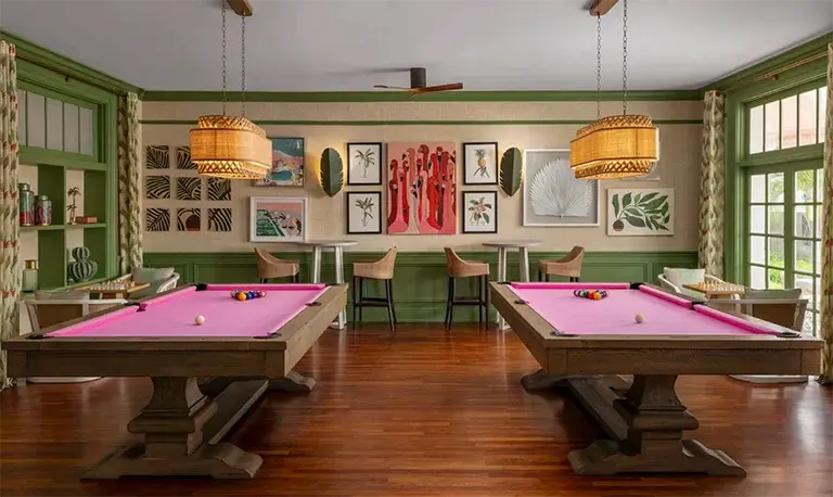 Game room with pool tables and gallery wall at Sandals Royal Bahamian