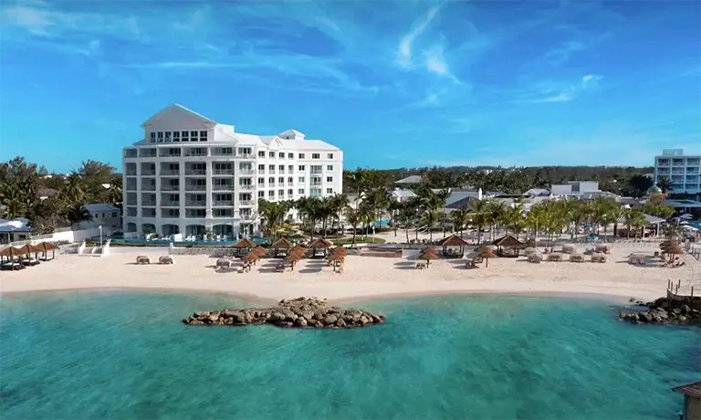 Aerial view of Sandals Royal Bahamian's oceanfront buildings and beach in Nassau