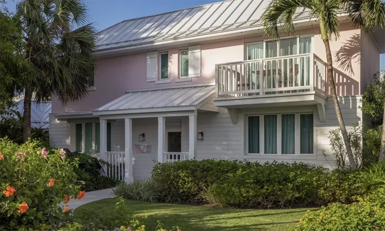 Pastel-colored villa exterior with balconies at Sandals Royal Bahamian, Nassau