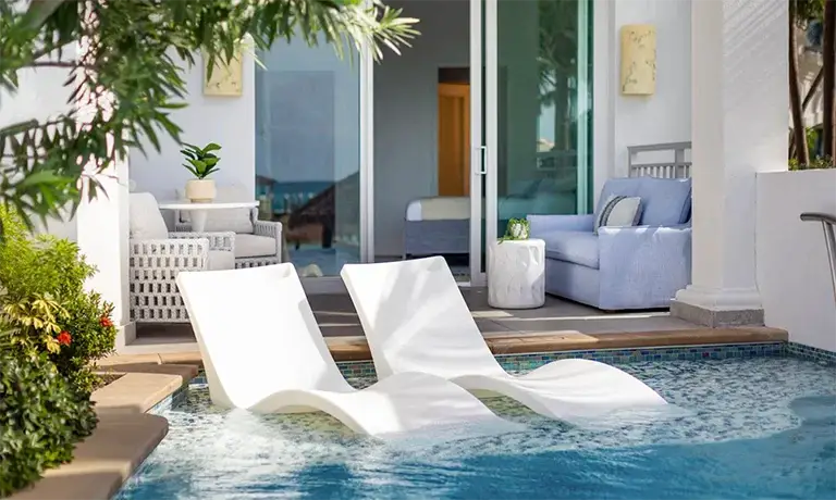Private plunge pool with lounge chairs at a villa suite at Sandals Royal Bahamian