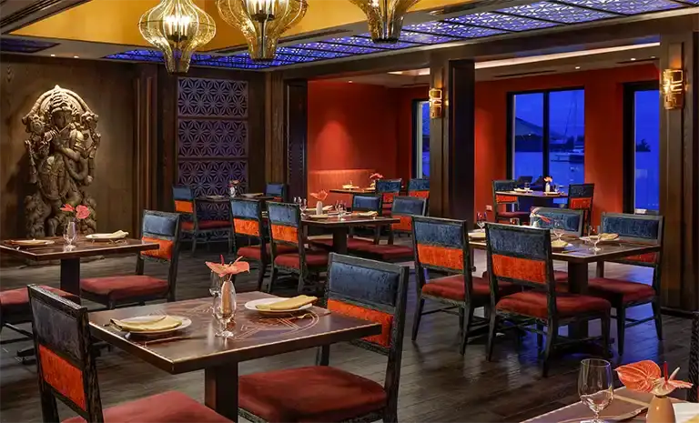 Asian-inspired restaurant interior with red accents at Sandals Royal Caribbean