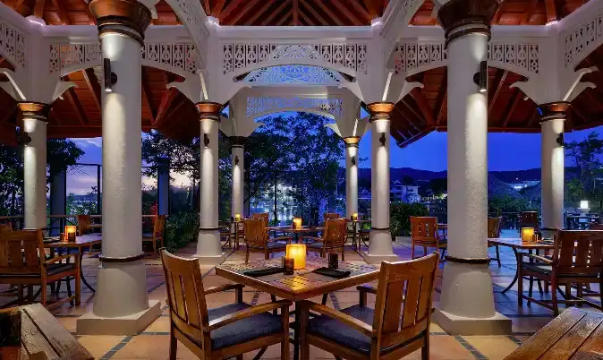 Elegant columned lounge area at Sandals Royal Caribbean in the evening