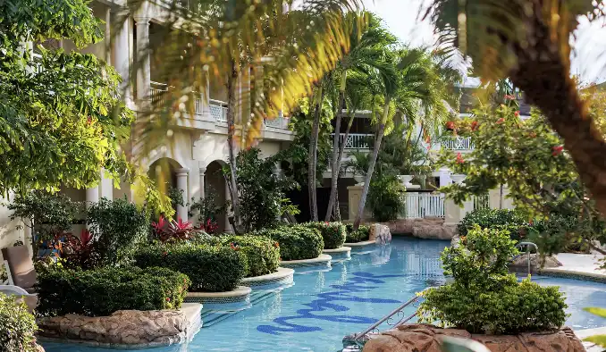 Garden pathway pool winding through tropical landscaping at Sandals Royal Caribbean