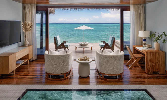 Oceanfront suite living room with panoramic beach views at Sandals Royal Caribbean
