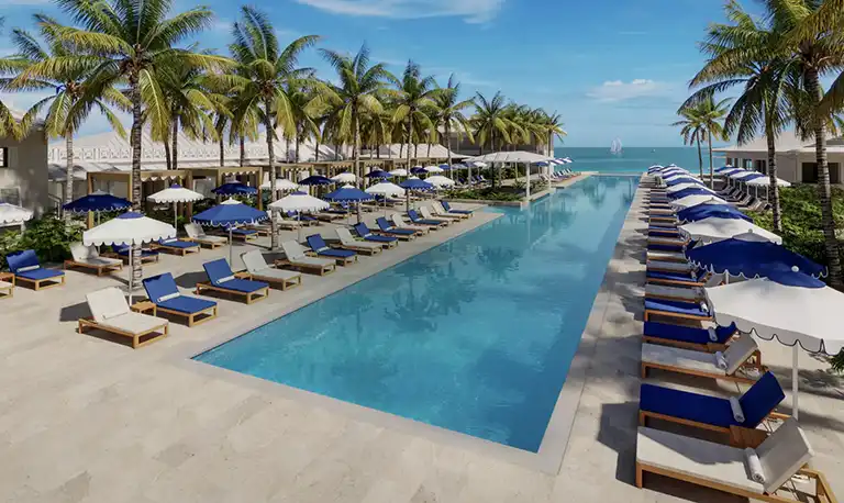 Poolside loungers and cabanas overlooking the ocean at Sandals Royal Caribbean
