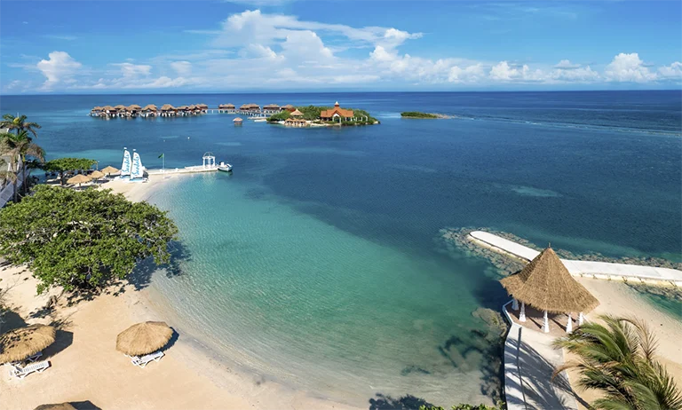 Aerial view of Sandals Royal Caribbean resort along the palm-lined coastline