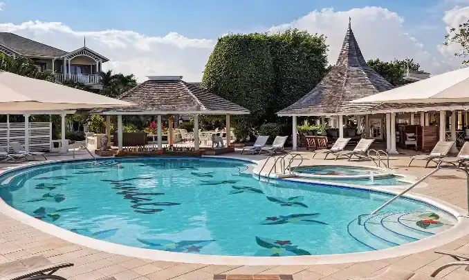 Round pool with fountain feature surrounded by gazebos at Sandals Royal Caribbean
